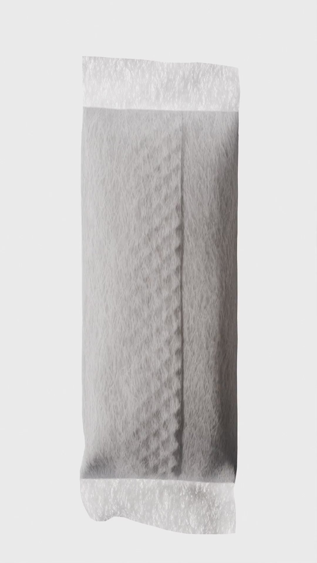 White rectangular nicotine pouch with fibrous texture on a plain background